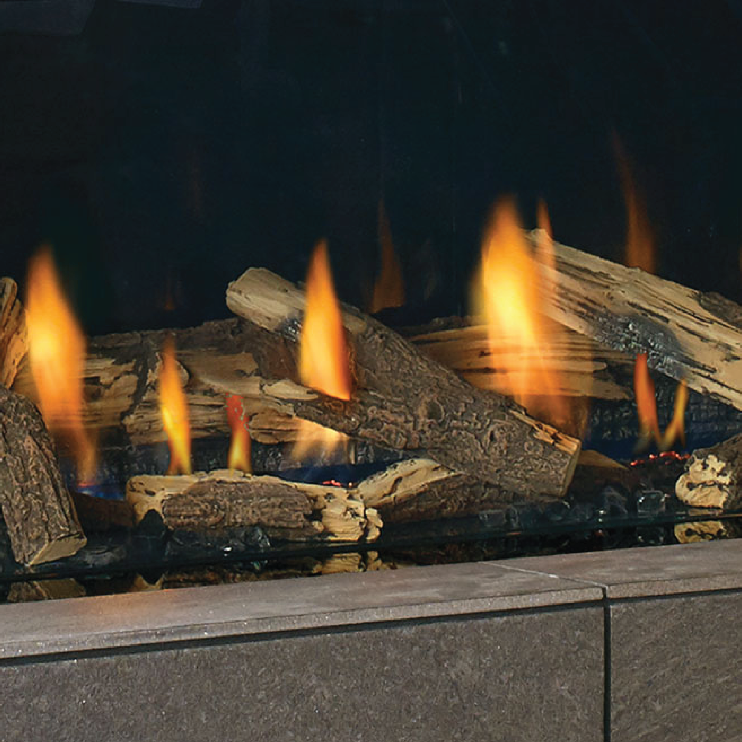 Split oak log set with glowing flames in a fireplace