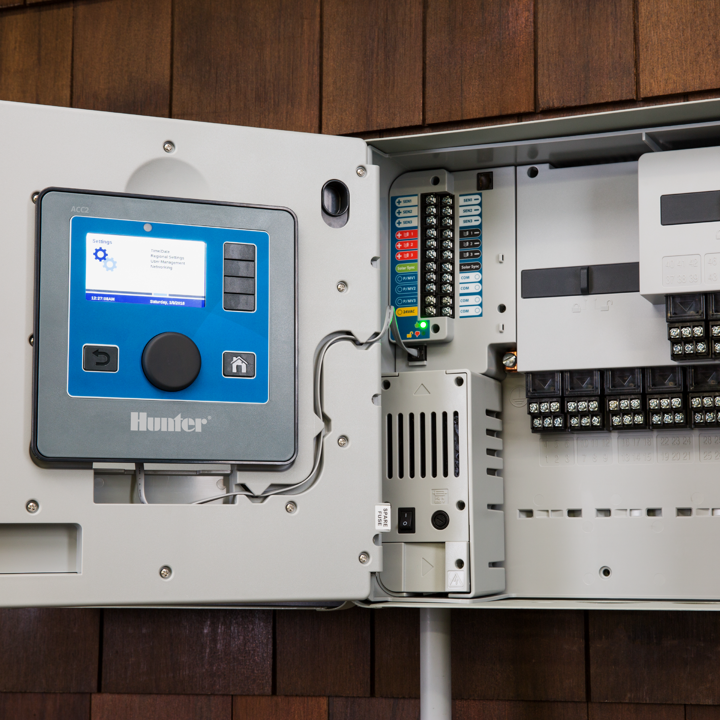 Wall-mounted plastic controller with interior terminal strips and circuit board