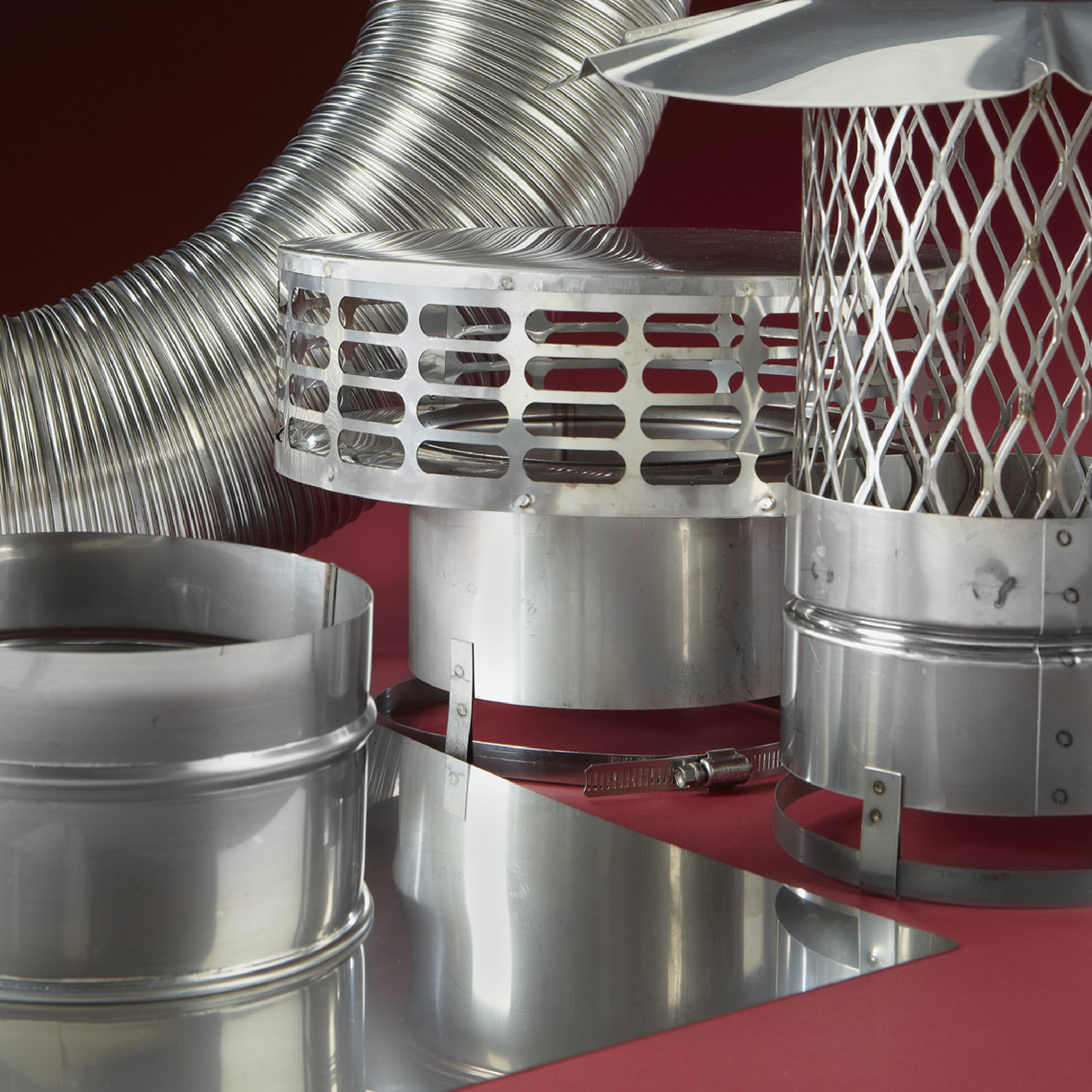 Installed stainless fireplace insert vent system with flexible liner and metal cap